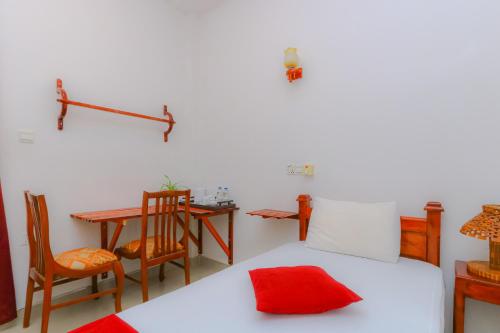 a bedroom with a bed and a table and chairs at Castle Resort Yala in Tissamaharama