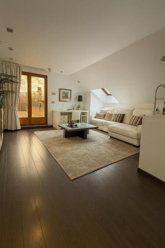 a living room with a couch and a table at Apartamentos Turisticos de Soria Moreras in Soria