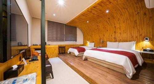 a bedroom with two beds in a room at Hotel Floce in Bucheon