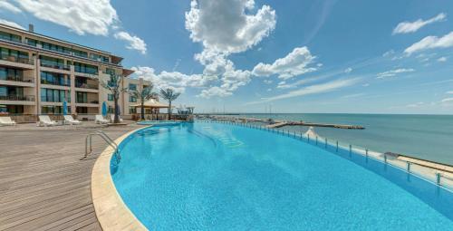 a swimming pool with a view of the ocean at Marina City ApartHotel in Balchik
