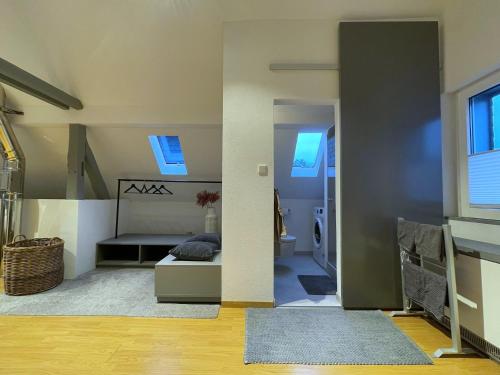 a living room with a bed and a hallway at stilvolles Ferienhaus mit Garten im Ortskern von Olsberg in Olsberg