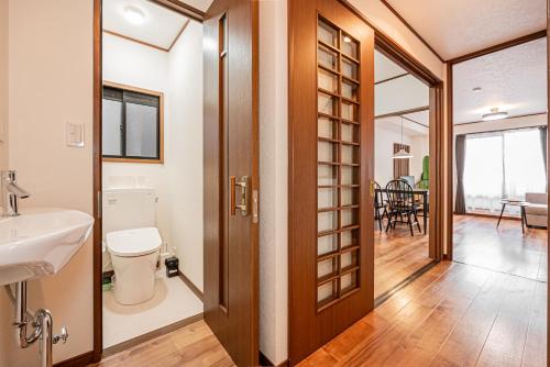 a bathroom with a toilet and a sink at Tokyo Stay House Hirai in Tokyo