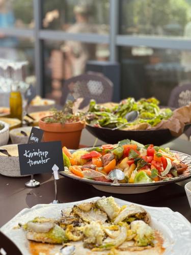 a table with several plates of food on it at Siggesta Gård in Värmdö
