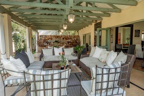 a patio with couches and chairs on a porch at The Parkwood in Johannesburg