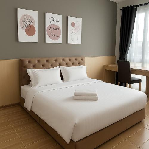 a bedroom with a large white bed and a desk at 3BR max 9pax near MRT Ratchada Good for group in Bangkok
