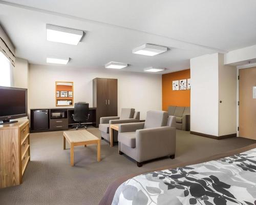 a hotel room with a bed and a flat screen tv at Sleep Inn Bessemer Helena in Bessemer