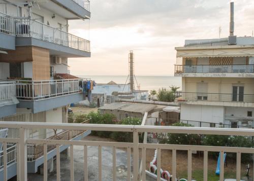 a view of the ocean from the balcony of a building at Thessaloniki Blue Escape by ΜΡS in Perea