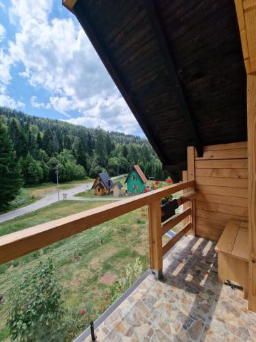 a view from the balcony of a log cabin at Brvnara Miris Bora in Šljivovica