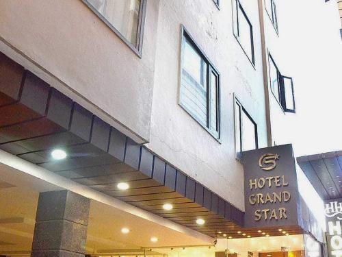 a hotel sign on the side of a building at Hotel O Grand Star in Amritsar