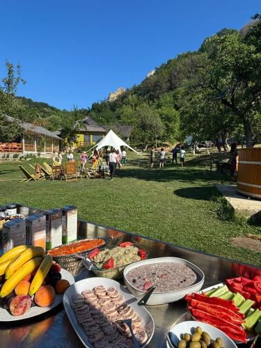 a table with many different types of food on it at Alunis GLAMPING in Aluniş