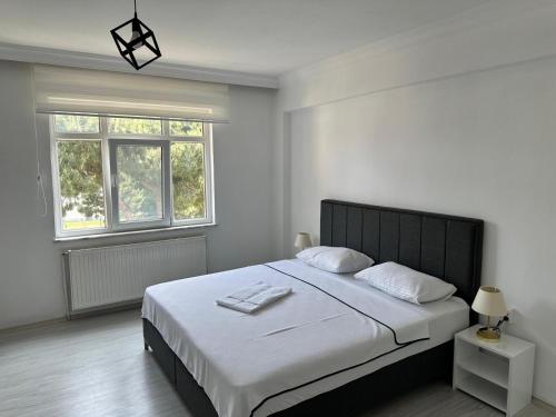 En eller flere senge i et værelse på Lotus Pansiyon Sinop