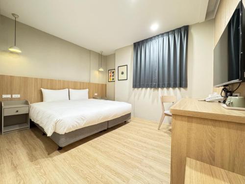 Un ou plusieurs lits dans un hébergement de l'établissement Yoshi Hotel - Tainan Sinmei Branch