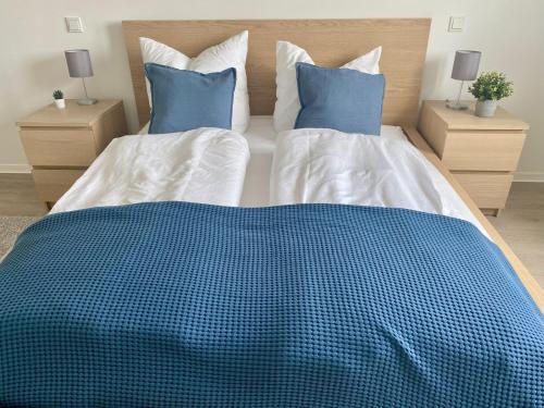 a bedroom with a blue and white bed with two pillows at Residenciano Celle in Celle