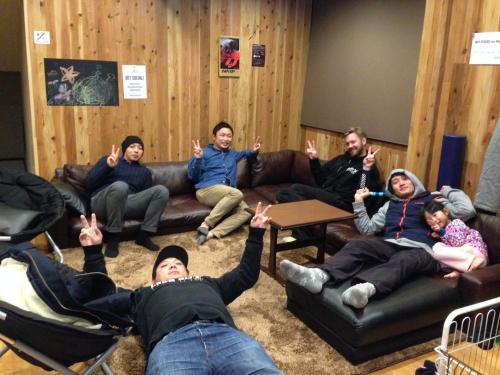 a group of people sitting on couches in a room at A short walk to Akakura Onsen Ski Lift and Town by Japow House in Myoko
