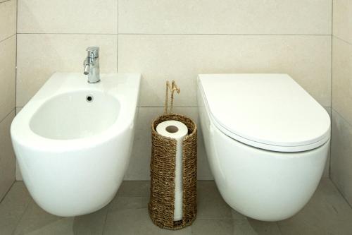 a bathroom with a toilet and a bidet at Ale house experience in Riola Sardo