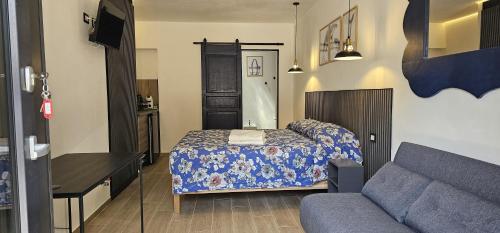 a small bedroom with a bed and a couch at Derosas House in Golfo Aranci