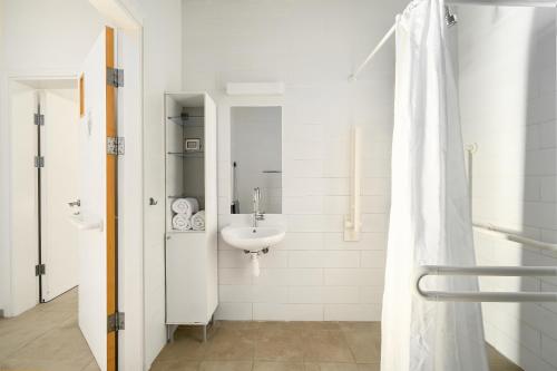 a white bathroom with a sink and a shower at Keshet Eilon Galilee Views Retreat by Sea N' Rent in Elon