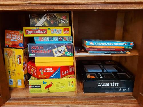 a stack of books sitting on a shelf at La Petite Maison in Vaiges
