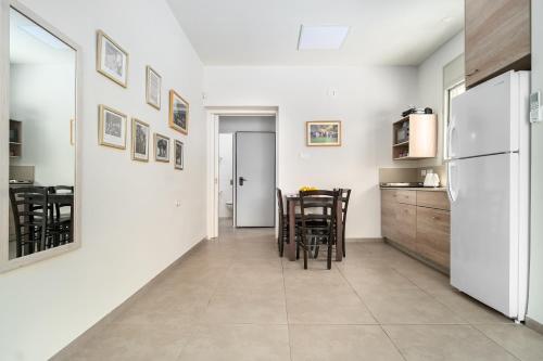a kitchen and dining room with a white refrigerator at Keshet Eilon Galilee Views Retreat by Sea N' Rent in Elon