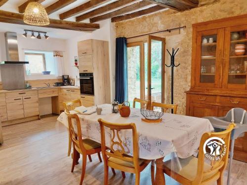 a kitchen and dining room with a table and chairs at La Petite Maison in Vaiges