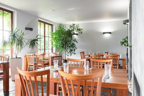 a dining room with wooden tables and chairs at Hotel Maroli Mikulov in Mikulov