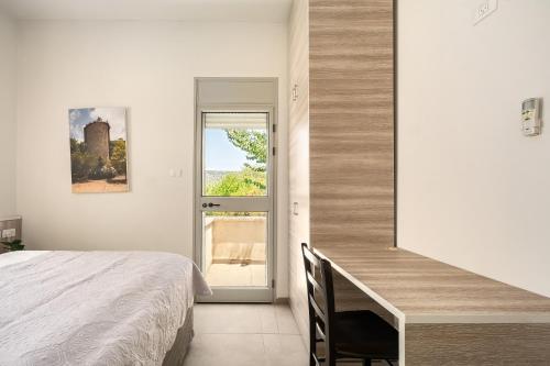 a bedroom with a bed and a desk and a window at Keshet Eilon Galilee Views Retreat by Sea N' Rent in Elon