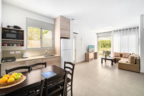 a kitchen and living room with a table and a refrigerator at Keshet Eilon Galilee Views Retreat by Sea N' Rent in Elon