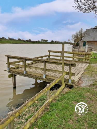 a wooden dock next to a body of water at Chalet le Vairon (PMR) in Villiers-Charlemagne