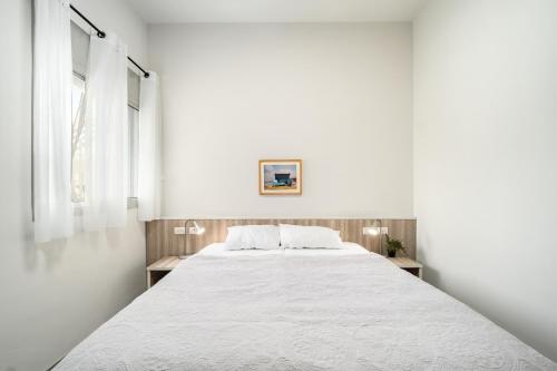 a large bed in a white room with two windows at Keshet Eilon Galilee Views Retreat by Sea N' Rent in Elon
