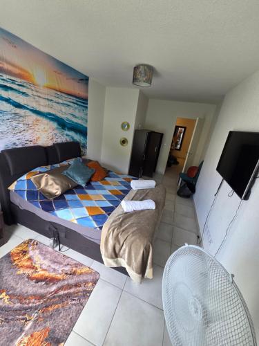 a bedroom with two beds and a flat screen tv at Appartement bella vista marseillan in Marseillan