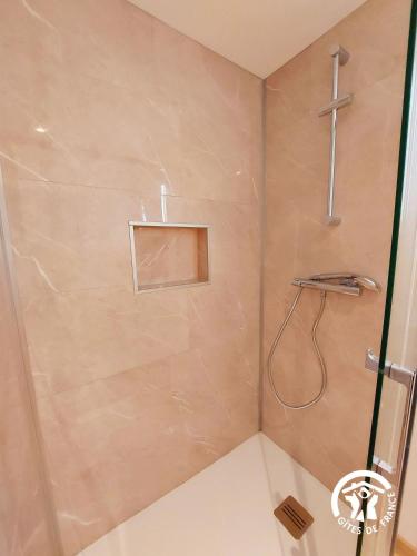 a shower in a bathroom with a wall at L'étoile du Berger in Montsûrs