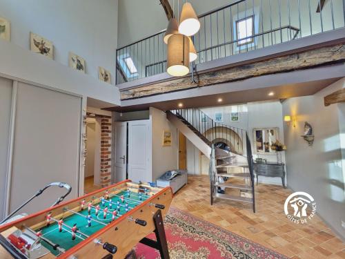a room with a foosball table and a staircase at Le Moulin Renaud, 8 personnes 
