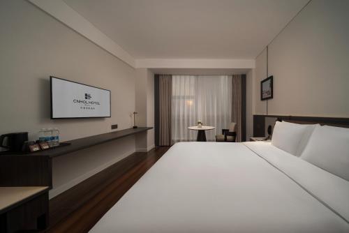 Cama o camas de una habitación en CNHOL RADIENT HOTEL Dongguan Humen