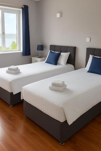 two beds sitting next to each other in a bedroom at Youghal in Youghal