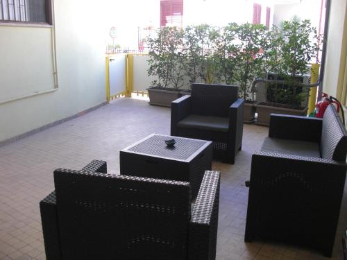 a room with black chairs and tables and plants at LE FONTI - CHARMING APARTMENT - PUGLIA INN HOLIDAY in Acquaviva delle Fonti
