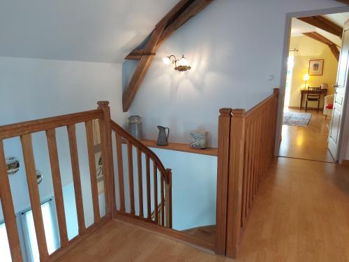 a room with a staircase and a hallway with a stair case at Gîte de la Houzardière, jusqu'à 7 pers in Bazougers