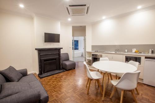 a living room with a table and a couch at The Mill Apartments Clare Valley in Clare