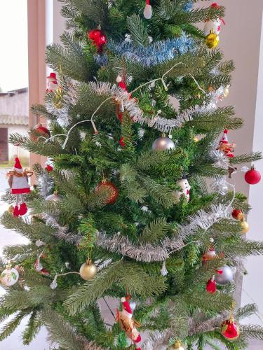 a christmas tree with christmas ornaments on it at Un air de campagne in Saint-Pierre-la-Cour