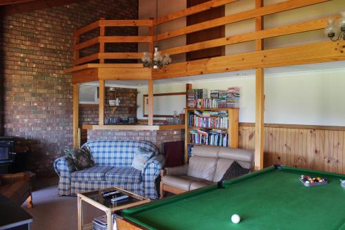 a living room with a pool table and a couch at Bott's Beach Retreat - Maslin Beach - 100M to beach in Maslin Beach