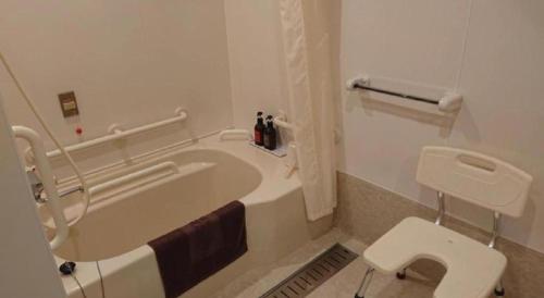 a bathroom with a bath tub and a toilet at Centrale Hotel Kyotango in Kyotango