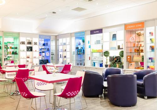 a store with red chairs and tables in a room at Vale Resort in Hensol