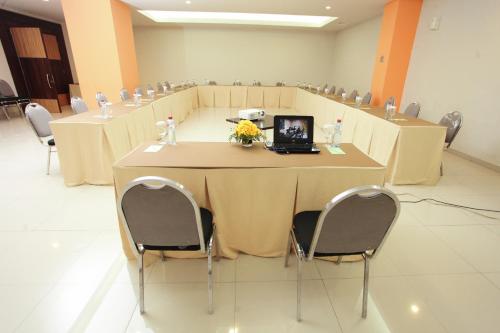 a conference room with a table with a laptop on it at The Square Surabaya Hotel in Surabaya