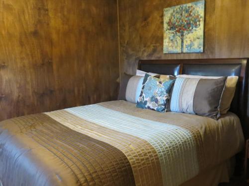 a bed with pillows on it in a bedroom at Orchard View Bed and Breakfast in Moose Jaw