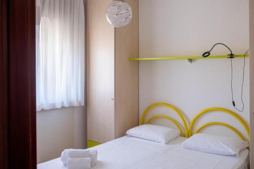 a bedroom with two beds and a window at Aurora Residence in Lido Adriano
