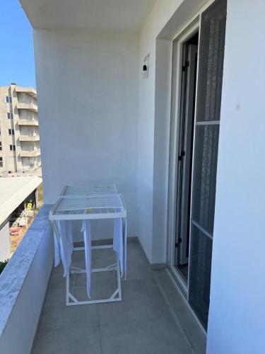 a blue table on the balcony of a building at 3rd Floor Mali i Robit Apartments in Golem