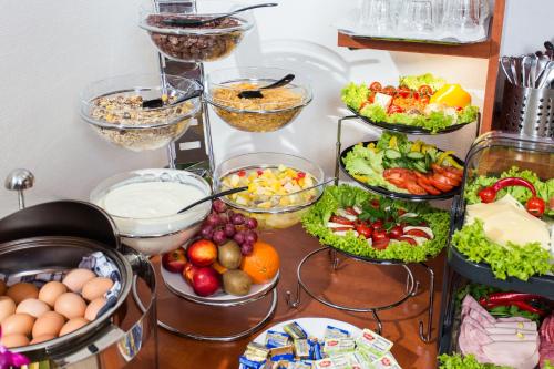 a table filled with bowls of food and vegetables at Hotel Condor in Hamburg