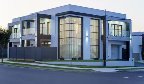 a rendering of a large building with glass at Brand New Designer House in Marsden Park