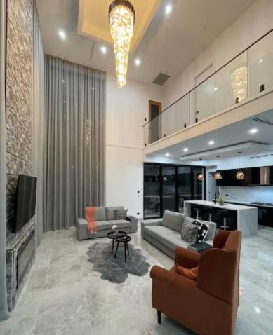 a living room with two couches and a television at Brand New Designer House in Marsden Park