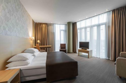 Vuode tai vuoteita majoituspaikassa Rixwell Elefant Hotel