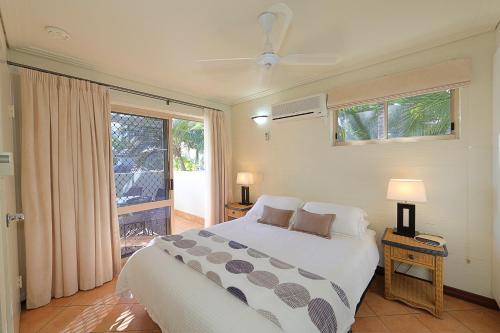 a bedroom with a large bed and a window at Bargara Shoreline Apartments in Bargara
